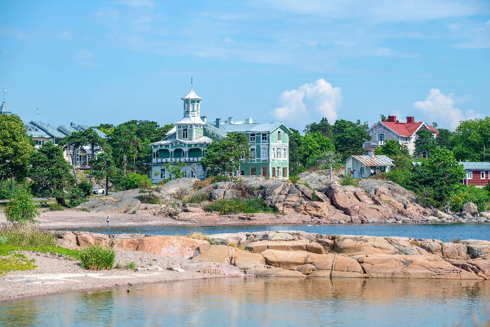 Scenic view of a coastal town Hanko (Finland) with houses and rocky shoreline.