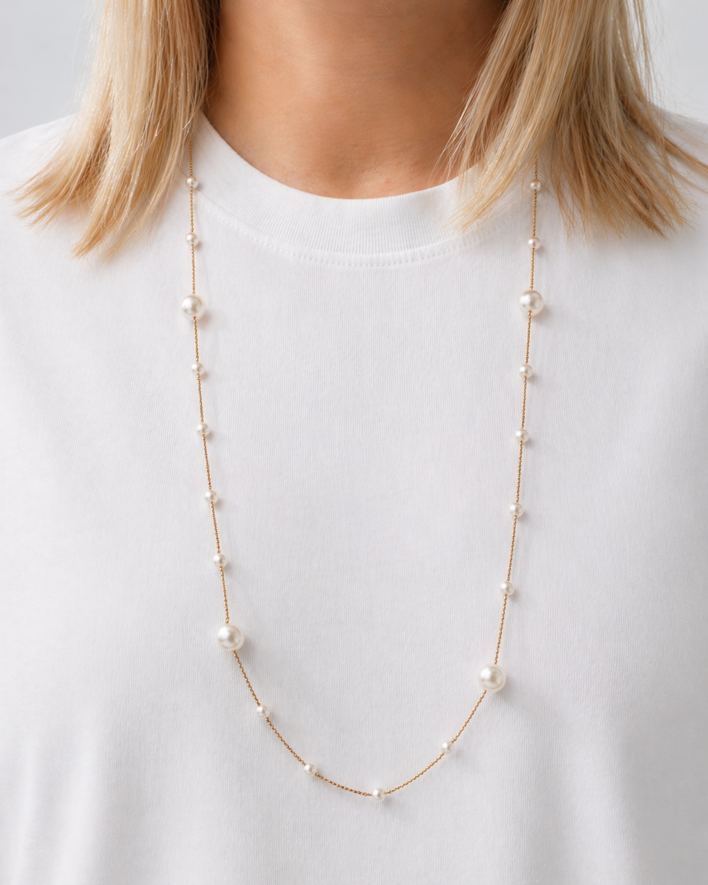 Gold-tone pearl chain necklace with delicate imitation pearls worn by a model by HNKO
